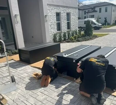 Two In A Zip Moving crew members in branded caps and shirts, one reaching out to shake hands